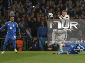 Cole Palmer of England is in the air and Dimitris Giannoulis of Greece is in action during the football game between England and Greece for...