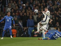 Cole Palmer of England is in the air and Dimitris Giannoulis of Greece is in action during the football game between England and Greece for...