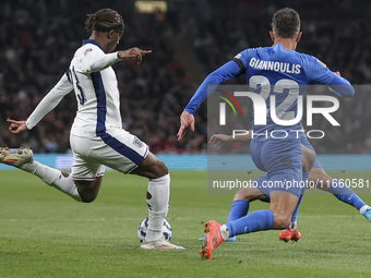 Noni Madueke of England kicks the ball next to Dimitris Giannoulis of Greece during the football game between England and Greece for the UEF...