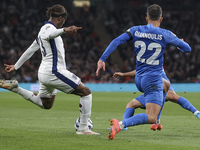 Noni Madueke of England kicks the ball next to Dimitris Giannoulis of Greece during the football game between England and Greece for the UEF...