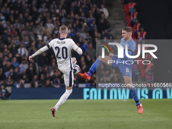 Cole Palmer of England and Christos Tzolis of Greece compete in the air for the ball during the football game between England and Greece for...