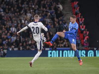 Cole Palmer of England and Christos Tzolis of Greece compete in the air for the ball during the football game between England and Greece for...