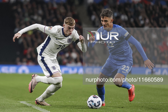 Cole Palmer of England and Dimitris Giannoulis of Greece play during the football game between England and Greece for the UEFA Nations Leagu...