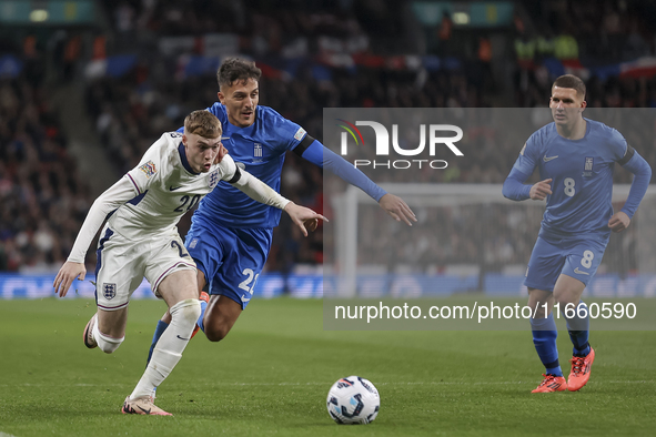 Cole Palmer of England and Dimitris Giannoulis of Greece are in action while Christos Tzolis of Greece reaches during the football game betw...