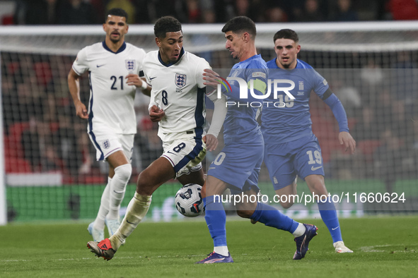 Jude Bellingham of England and Petros Mantalos of Greece compete for the ball during the football game between England and Greece for the UE...