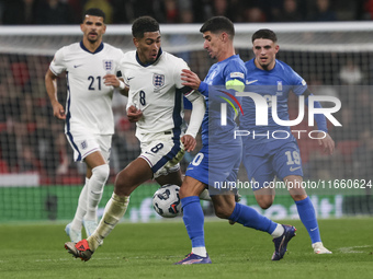 Jude Bellingham of England and Petros Mantalos of Greece compete for the ball during the football game between England and Greece for the UE...