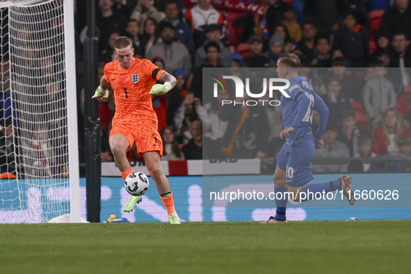 Goalkeeper Jordan Pickford of England holds the ball as Dimitris Pelkas of Greece is in action during the football game between England and...