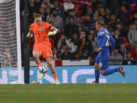 Goalkeeper Jordan Pickford of England holds the ball as Dimitris Pelkas of Greece is in action during the football game between England and...