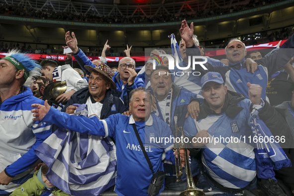 Fans of the Greek football team cheer, sing, and celebrate after the historic win. The football game between England and Greece for the UEFA...