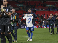 Tasos Bakasetas holds an official jersey with the name BALDOCK while he appears emotional. The Greek team heads to the Greek fans to celebra...