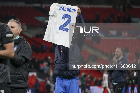 Tasos Bakasetas holds an official jersey with the name BALDOCK while he appears emotional. The Greek team heads to the Greek fans to celebra...