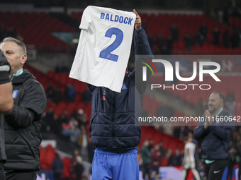 Tasos Bakasetas holds an official jersey with the name BALDOCK while he appears emotional. The Greek team heads to the Greek fans to celebra...