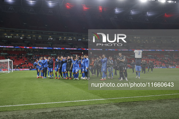 Tasos Bakasetas holds an official jersey with the name BALDOCK while he appears emotional. The Greek team heads to the Greek fans to celebra...