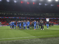 Tasos Bakasetas holds an official jersey with the name BALDOCK while he appears emotional. The Greek team heads to the Greek fans to celebra...