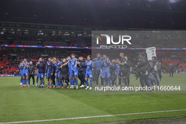 Tasos Bakasetas holds an official jersey with the name BALDOCK while he appears emotional. The Greek team heads to the Greek fans to celebra...