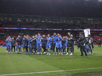 Tasos Bakasetas holds an official jersey with the name BALDOCK while he appears emotional. The Greek team heads to the Greek fans to celebra...