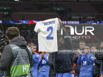 Tasos Bakasetas holds an official jersey with the name BALDOCK while he appears emotional. The Greek team heads to the Greek fans to celebra...