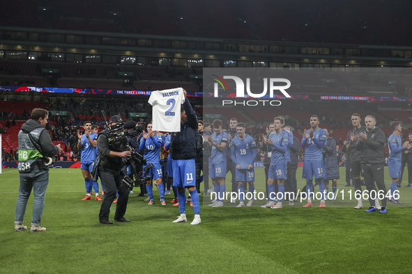 Tasos Bakasetas holds an official jersey with the name BALDOCK while he appears emotional. The Greek team heads to the Greek fans to celebra...