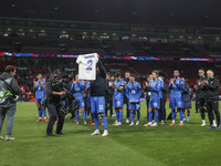 Tasos Bakasetas holds an official jersey with the name BALDOCK while he appears emotional. The Greek team heads to the Greek fans to celebra...