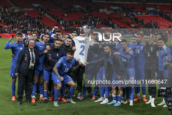 The Greek team stands in front of the side with the Greek fans, celebrating and thanking them. They dedicate their win to their late teammat...