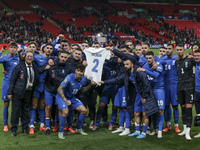 The Greek team stands in front of the side with the Greek fans, celebrating and thanking them. They dedicate their win to their late teammat...