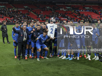 The Greek team stands in front of the side with the Greek fans, celebrating and thanking them. They dedicate their win to their late teammat...