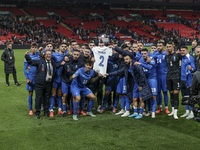 The Greek team stands in front of the side with the Greek fans, celebrating and thanking them. They dedicate their win to their late teammat...