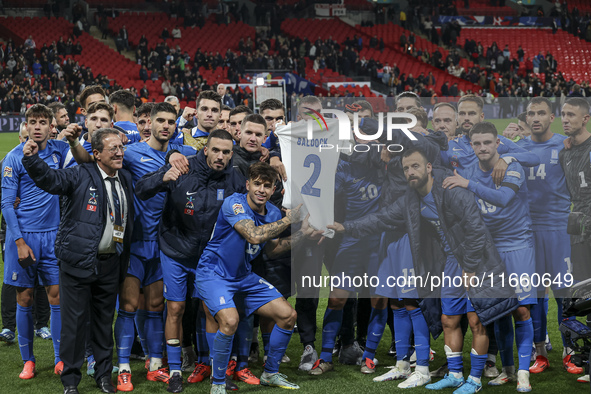 The Greek team stands in front of the side with the Greek fans, celebrating and thanking them. They dedicate their win to their late teammat...