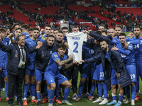 The Greek team stands in front of the side with the Greek fans, celebrating and thanking them. They dedicate their win to their late teammat...