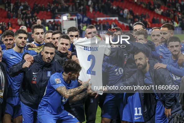 The Greek team stands in front of the side with the Greek fans, celebrating and thanking them. They dedicate their win to their late teammat...