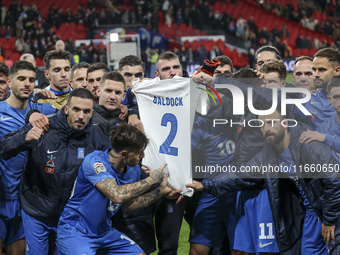 The Greek team stands in front of the side with the Greek fans, celebrating and thanking them. They dedicate their win to their late teammat...