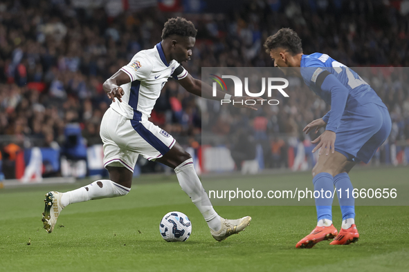 Bukayo Saka of England and Dimitris Giannoulis of Greece are in action during the football game between England and Greece for the UEFA Nati...