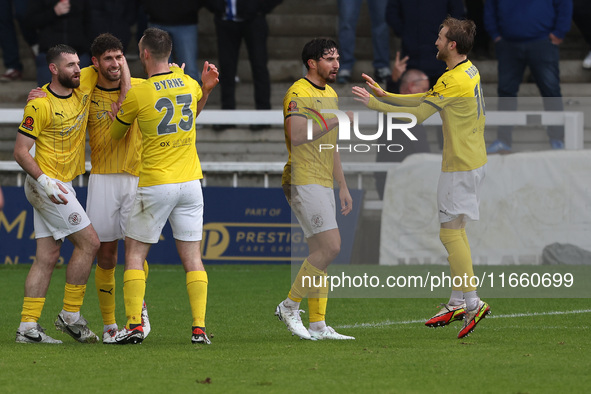 George Carline of Brackley Town celebrates with his teammates after scoring their first goal during the FA Cup Fourth Qualifying Round match...