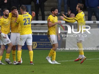 George Carline of Brackley Town celebrates with his teammates after scoring their first goal during the FA Cup Fourth Qualifying Round match...