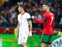 Cristiano Ronaldo reacts after scoring a goal while Robert Lewandowski looks on during the UEFA 2024 UEFA Nations League Group A1 match betw...