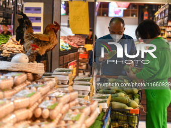 Citizens shop at a supermarket in Fuyang, China, on October 13, 2024. On the same day, the National Bureau of Statistics releases data showi...