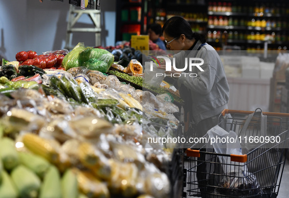 Citizens shop at a supermarket in Fuyang, China, on October 13, 2024. On the same day, the National Bureau of Statistics releases data showi...