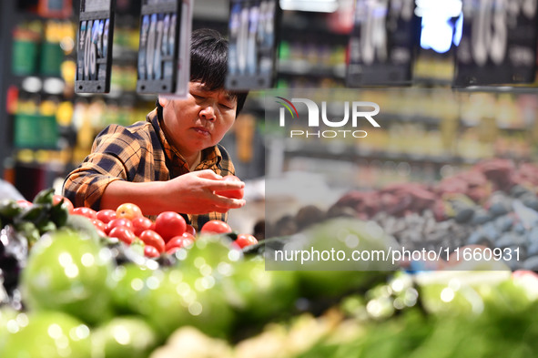 Citizens shop at a supermarket in Fuyang, China, on October 13, 2024. On the same day, the National Bureau of Statistics releases data showi...