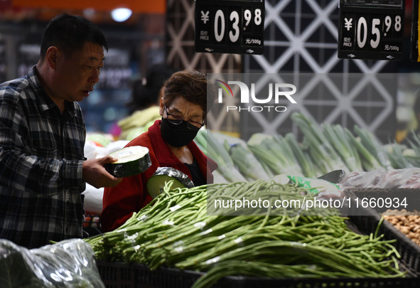 Citizens shop at a supermarket in Fuyang, China, on October 13, 2024. On the same day, the National Bureau of Statistics releases data showi...