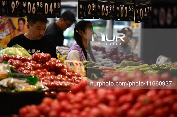 Citizens shop at a supermarket in Fuyang, China, on October 13, 2024. On the same day, the National Bureau of Statistics releases data showi...