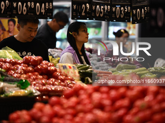 Citizens shop at a supermarket in Fuyang, China, on October 13, 2024. On the same day, the National Bureau of Statistics releases data showi...