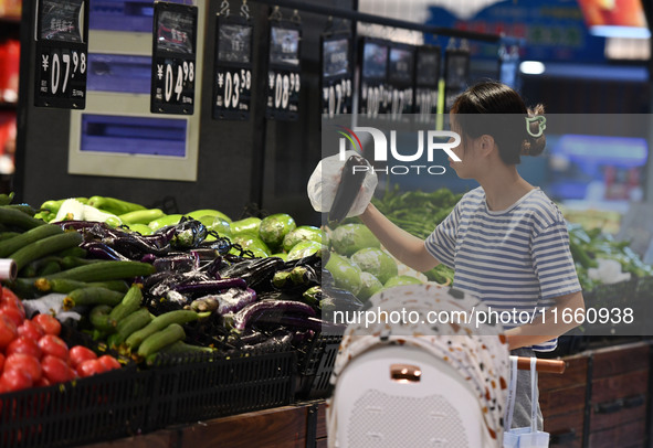 Citizens shop at a supermarket in Fuyang, China, on October 13, 2024. On the same day, the National Bureau of Statistics releases data showi...