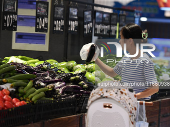 Citizens shop at a supermarket in Fuyang, China, on October 13, 2024. On the same day, the National Bureau of Statistics releases data showi...