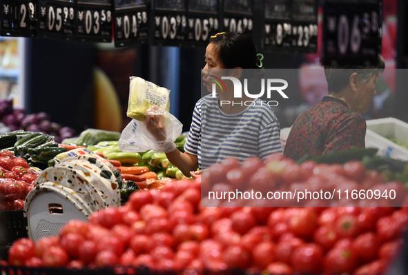 Citizens shop at a supermarket in Fuyang, China, on October 13, 2024. On the same day, the National Bureau of Statistics releases data showi...