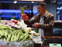 Citizens shop at a supermarket in Fuyang, China, on October 13, 2024. On the same day, the National Bureau of Statistics releases data showi...