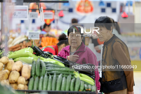 Citizens shop at a supermarket in Zaozhuang, China, on October 13, 2024. On the same day, the National Bureau of Statistics releases data sh...