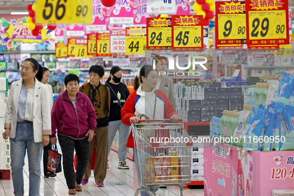 Citizens shop at a supermarket in Zaozhuang, China, on October 13, 2024. On the same day, the National Bureau of Statistics releases data sh...