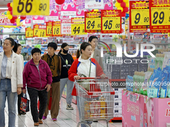 Citizens shop at a supermarket in Zaozhuang, China, on October 13, 2024. On the same day, the National Bureau of Statistics releases data sh...