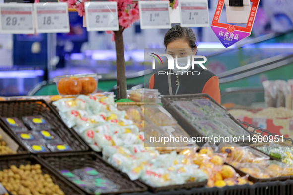 Citizens shop at a supermarket in Zaozhuang, China, on October 13, 2024. On the same day, the National Bureau of Statistics releases data sh...