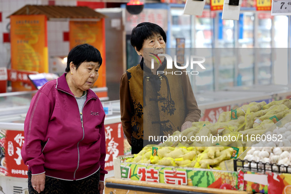 Citizens shop at a supermarket in Zaozhuang, China, on October 13, 2024. On the same day, the National Bureau of Statistics releases data sh...